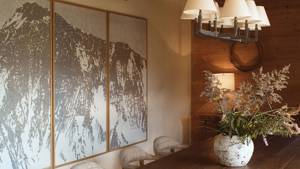 A clicked photo shows a dining area with a flower vase and unique art portrait.