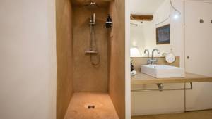 A bathroom photo features a shower faucet stand and a rectangular mirror above the washbasin.