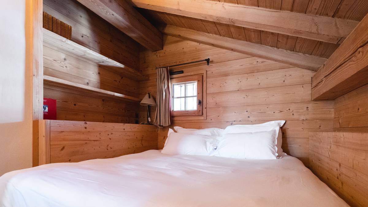 A cozy bed is adorned with feather-touch pillows, creating a soft and inviting space.