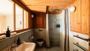 A photo captures a modern bathroom with all essentials neatly arranged and properly placed throughout.