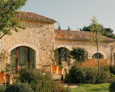 Façade en pierre provençale et jardins de l'hôtel Beaumier Capelongue à Bonnieux