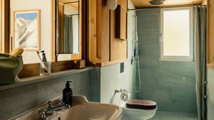 A photo showcases a modern bathroom with all essentials neatly arranged and properly placed throughout.