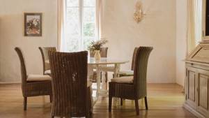 A properly arranged dining area features a round dining table accompanied by six chairs.