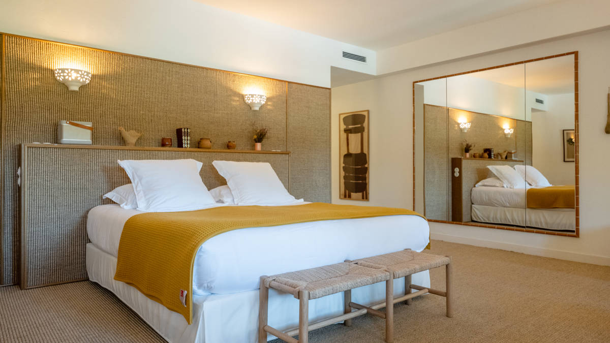 A well-organized bedroom features a cozy bed with decorative items placed on the headboard.