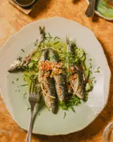 Cooked fish with fresh herbs in Estelo Restaurant