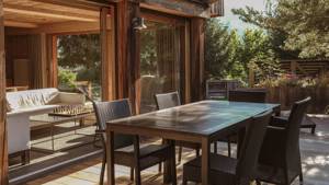 A clicked photo shows a long dining table with several chairs placed in the open air.