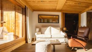A photo of the living space features a cozy sofa set placed near the window.