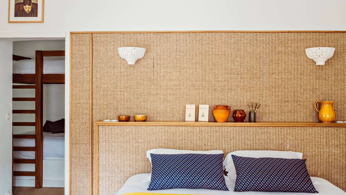 A properly arranged bedroom features a cozy bed with decorative items placed on the headboard.