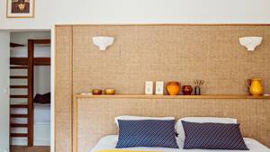 A properly arranged bedroom features a cozy bed with decorative items placed on the headboard.