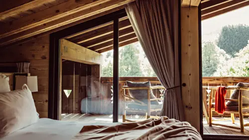 A clicked photo shows a cozy chair on the balcony offering a wonderful tree view.